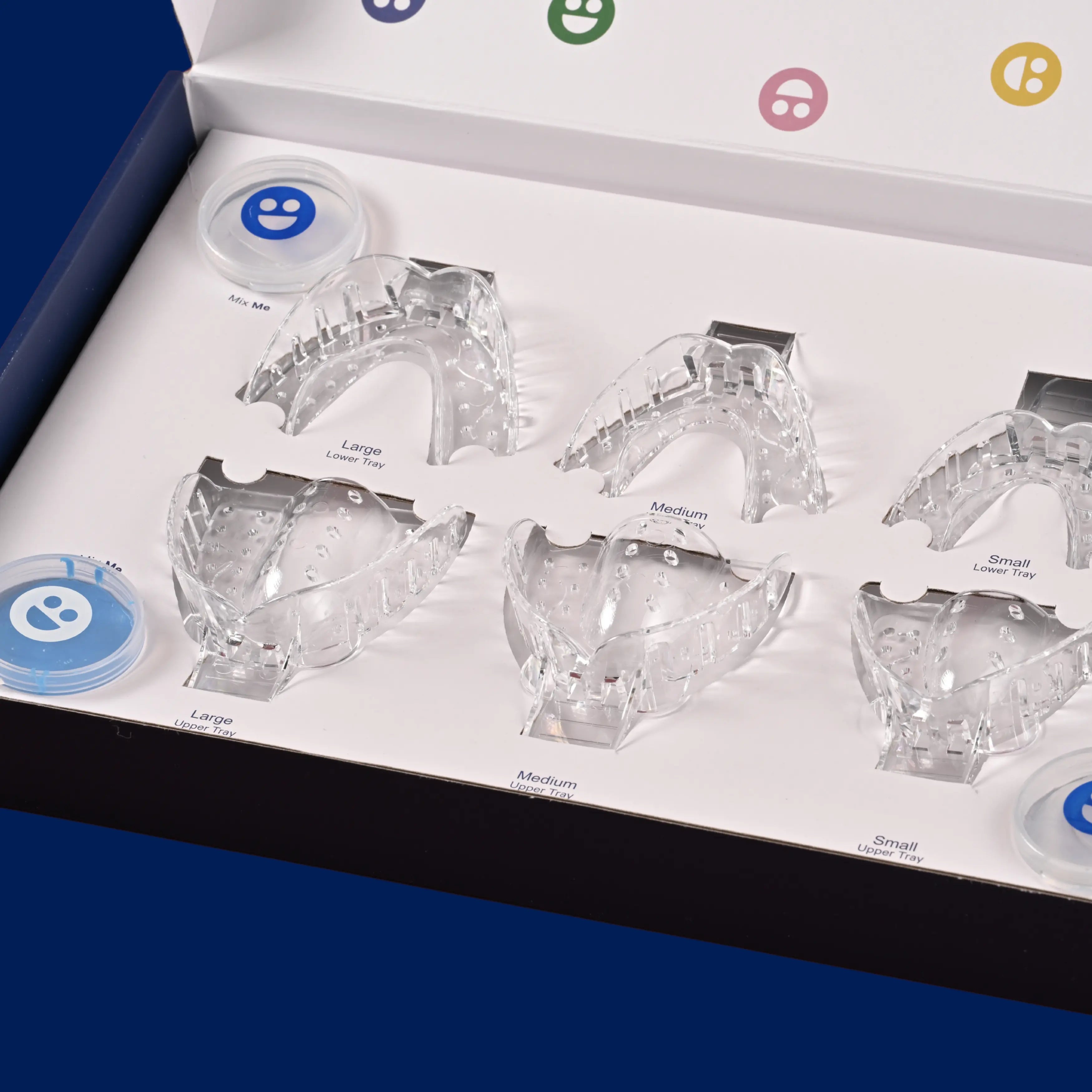 Set of clear dental models in a box with labeled sizes on a blue background